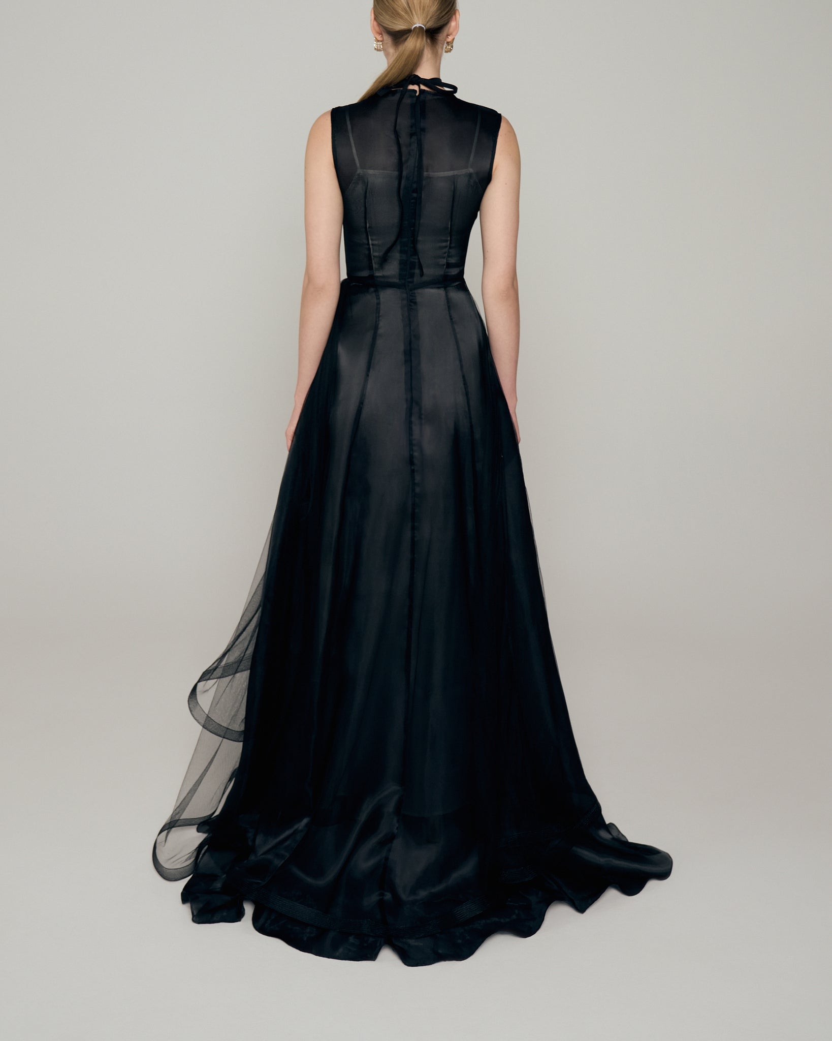 Black organza gown with tulle drape overlay and asymmetrical hem