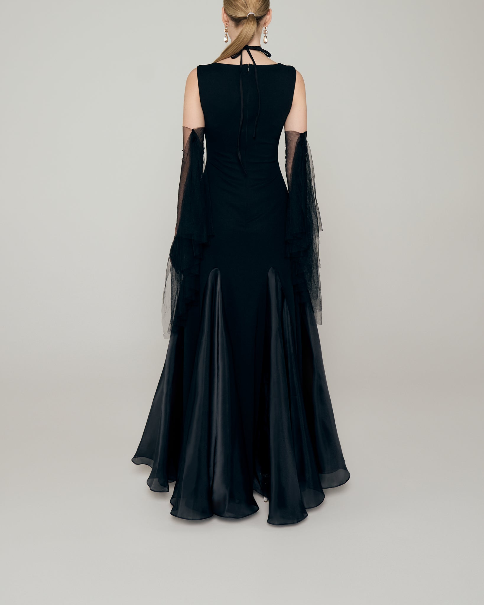 Sleeveless stretch crepe a line gown with neckline cutout, organza inserts, and tulle fringe gloves