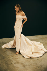 Off shoulder skinny gown with oversized statement train