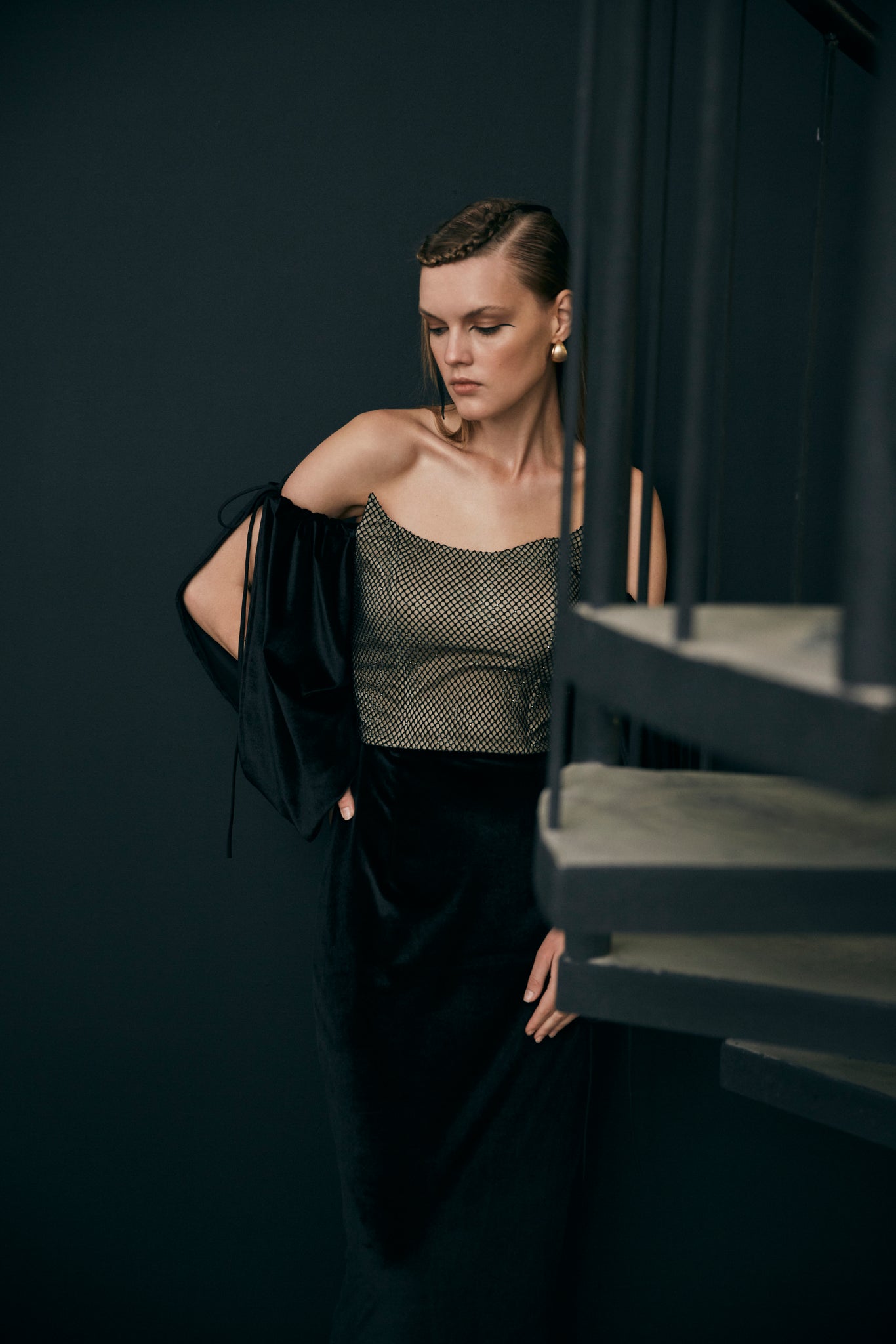 Black off- shoulder velvet gown with embellished bodice and puff sleeve